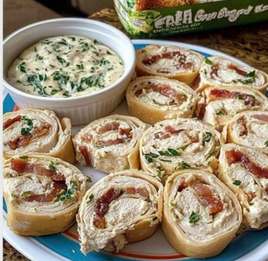 A plate of sliced chicken bacon ranch pinwheels garnished with fresh parsley.