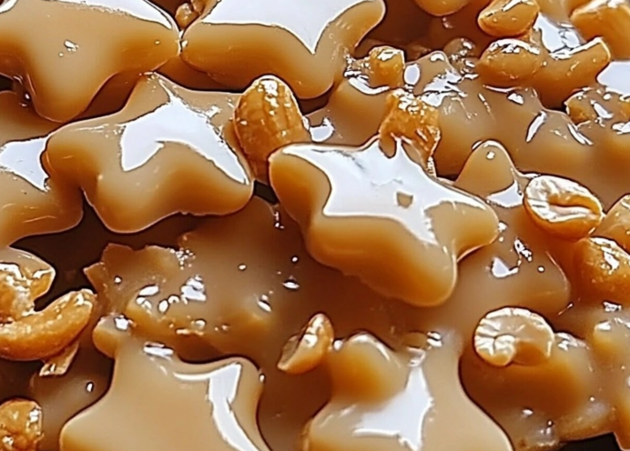 Cashew Brittle Recipe – A bowl of glossy, caramel-coated cashew brittle pieces, showcasing their sweet and crunchy texture.