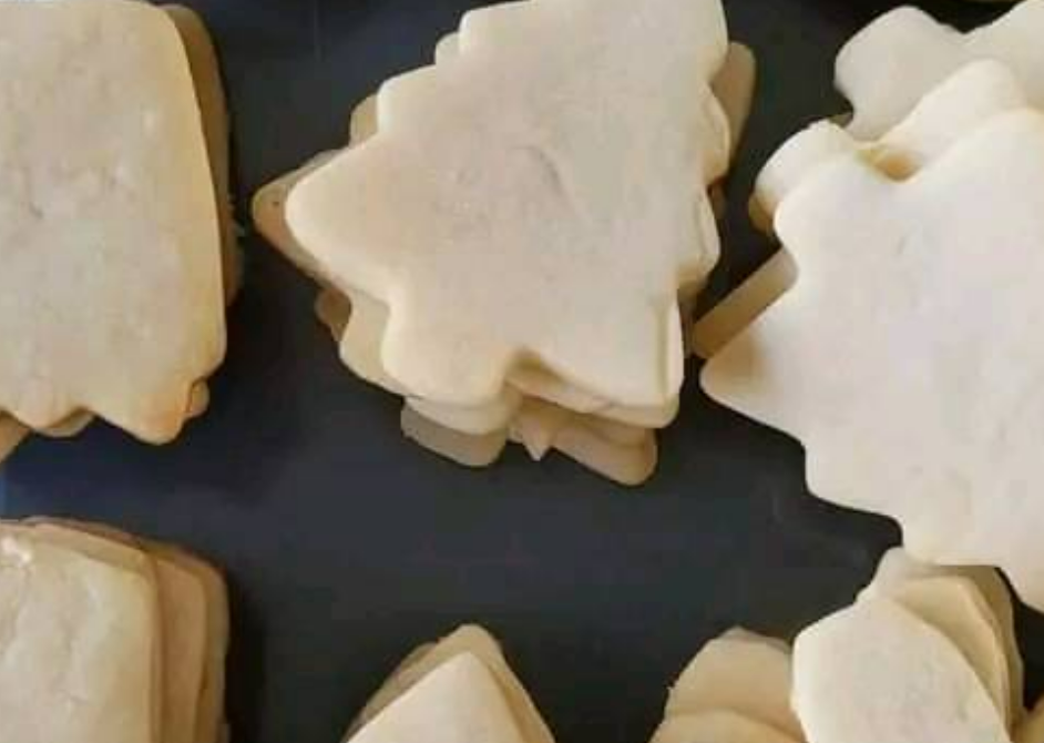 Classic cut-out sugar cookies in various holiday shapes, baked to perfection and ready for decorating.