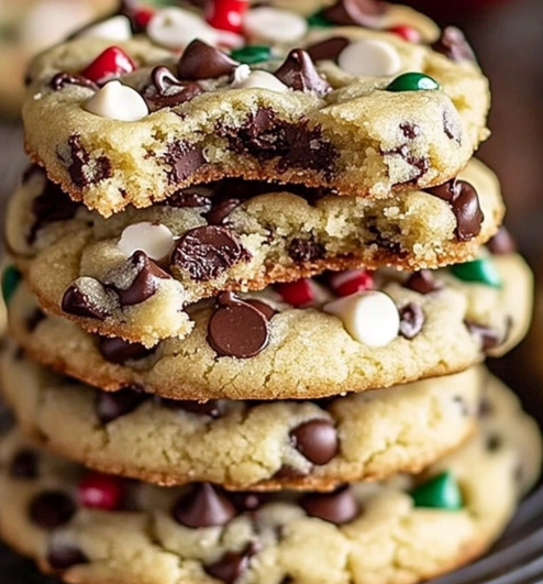 Winter Wonderland Chocolate Chip Christmas Cookies with festive sprinkles and chocolate chunks stacked on a wire rack.