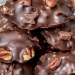 Chocolate Pecan Clusters Recipe – Decadent chocolate-covered pecans stacked on a plate.