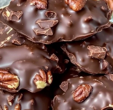 Chocolate Pecan Clusters Recipe – Decadent chocolate-covered pecans stacked on a plate.